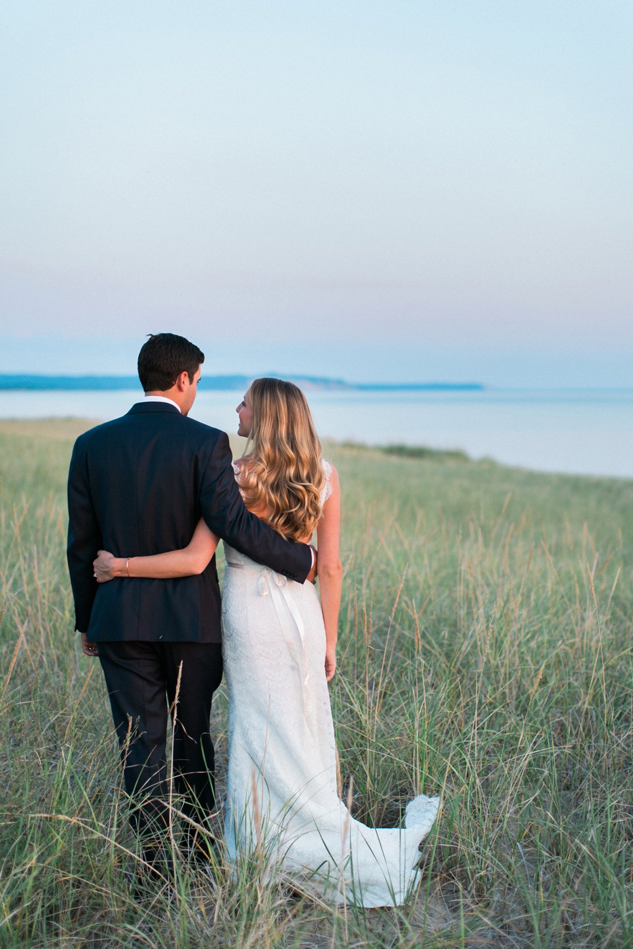 Romantic Bride & groom sunset portraits in the dune grass along the lakeshore in Elberta, Michigan