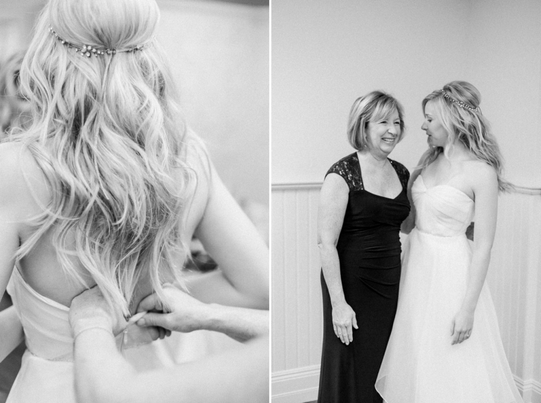 A bride getting her wedding gown on with the help of her mother