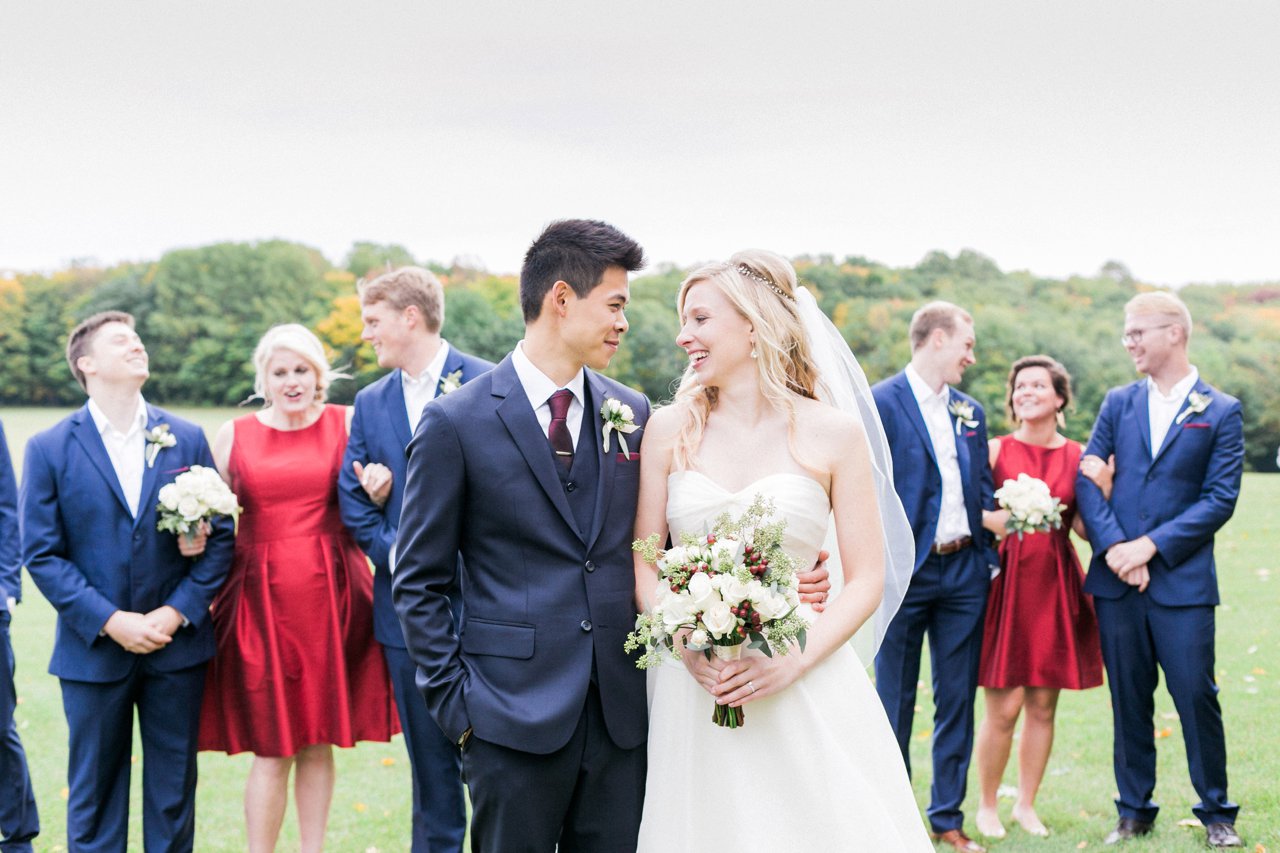 A bride and groom taking portraits with their wedding party in Harbor Springs, Michigan