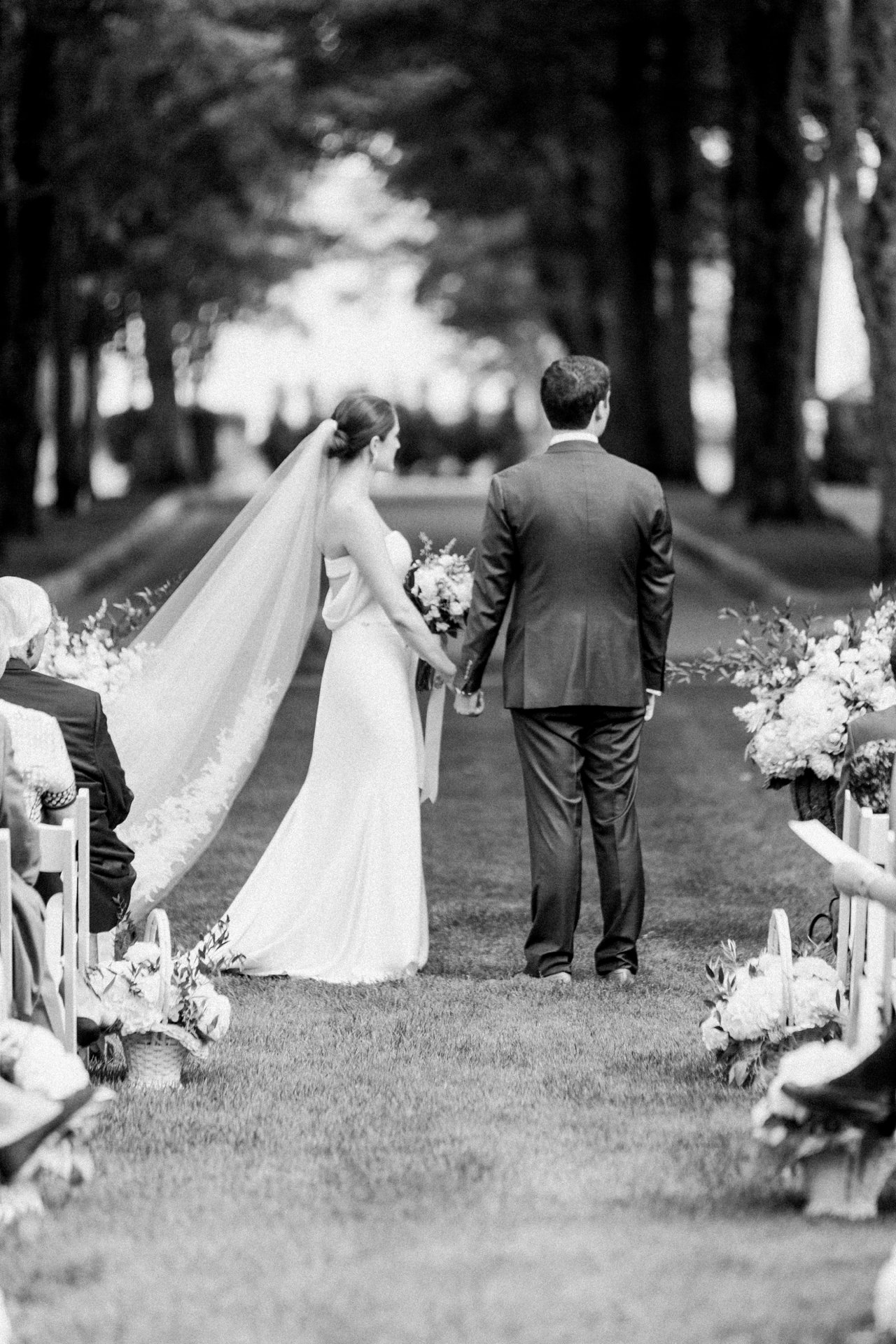 Black and white photo of a bride and groom at their wedding ceremony
