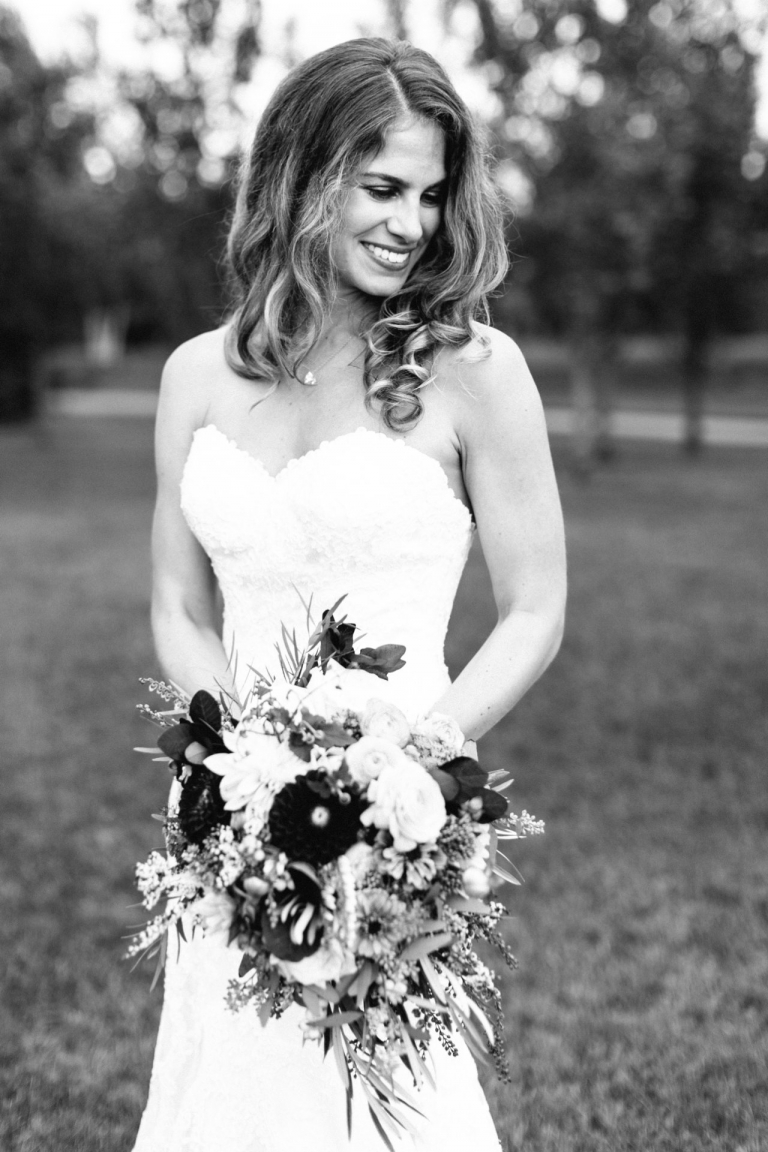 This is a black and white photo of a bride holding her bouquet in Northern Michigan. 