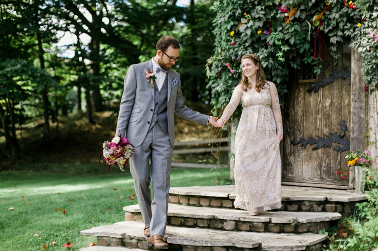 This is a photo of a bride and groom walking down steps in Northern Michigan.