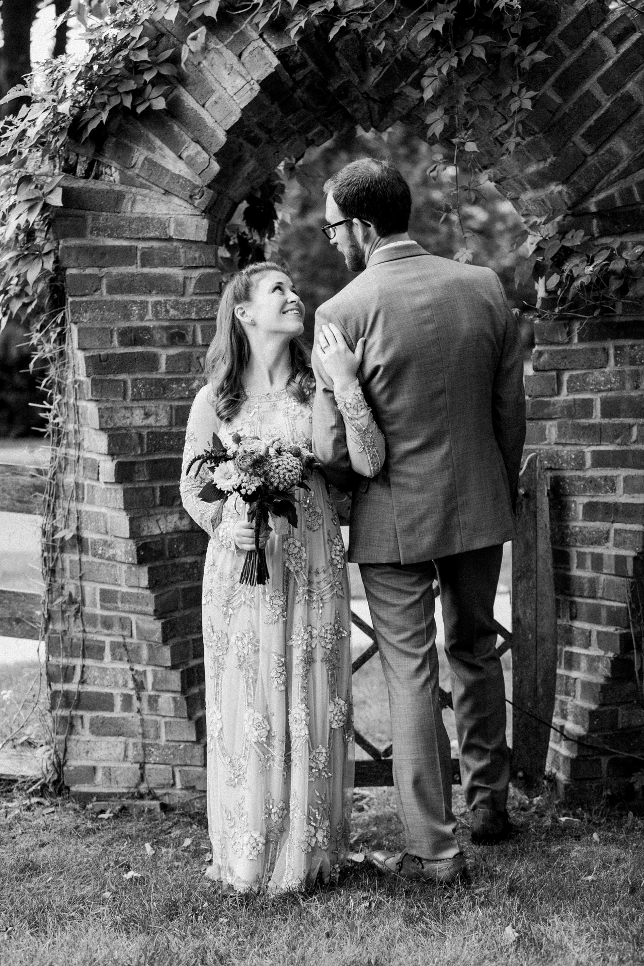 This is a photo of a bride looking up at her husband and smiling. 