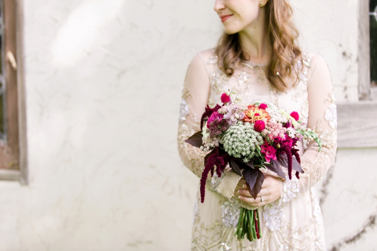 This is a photo of a bride holding her beautiful bouquet of flowers in Charlevoix, Michigan.