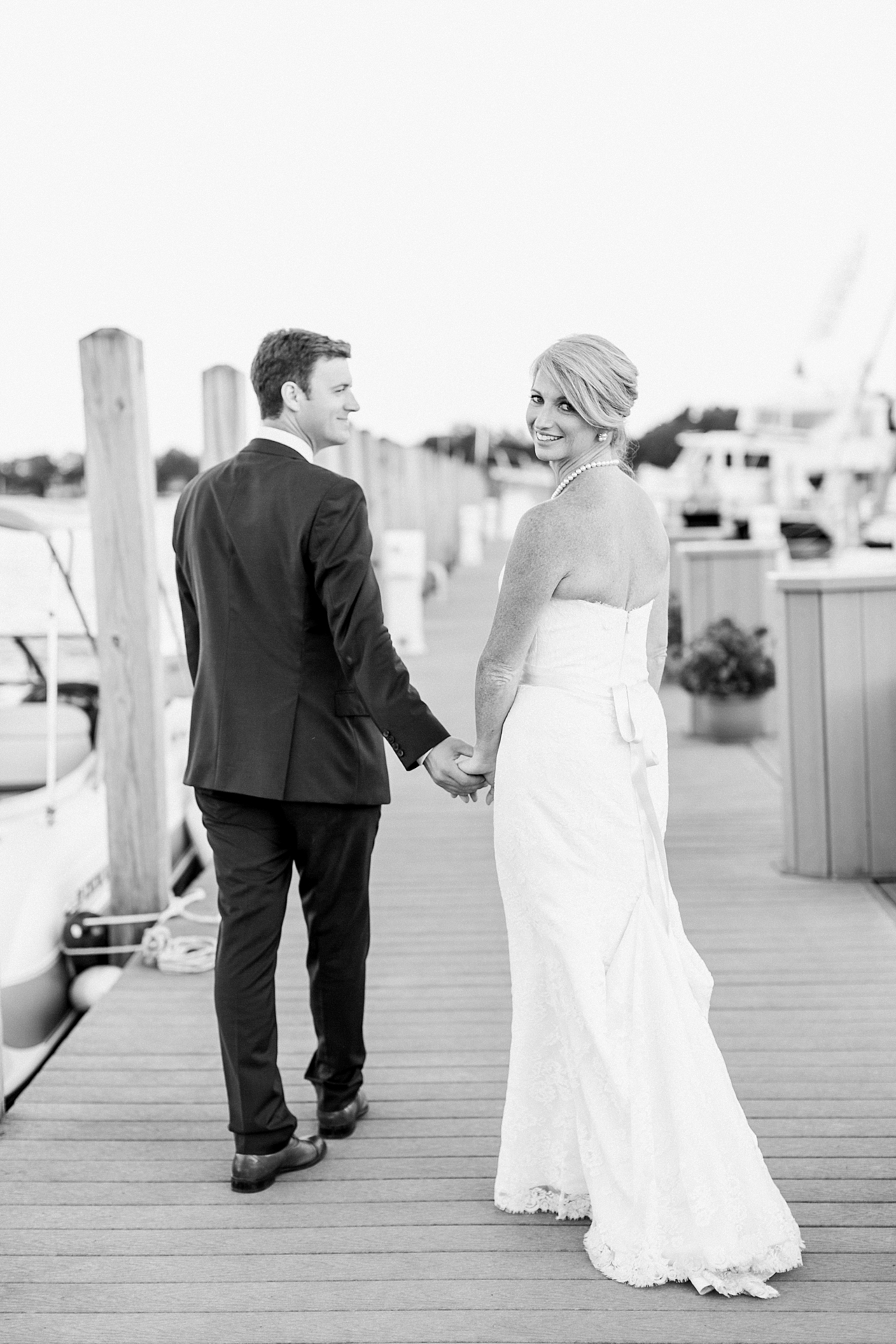 Black and white bride and groom portraits at a marina in Harbor Springs, Michigan