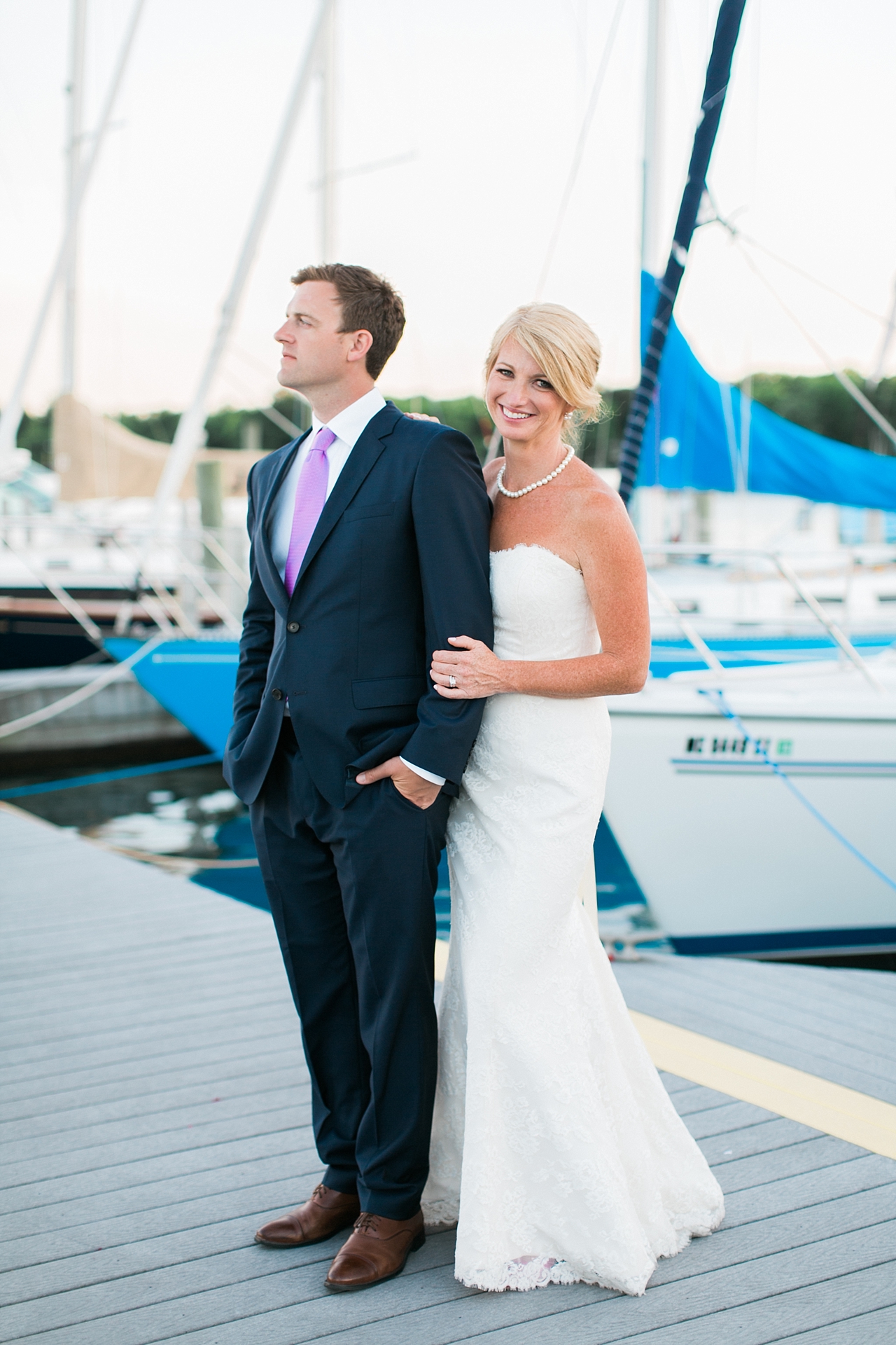 Wedding portraits of the bride and groom on a dock in Northern Michigan