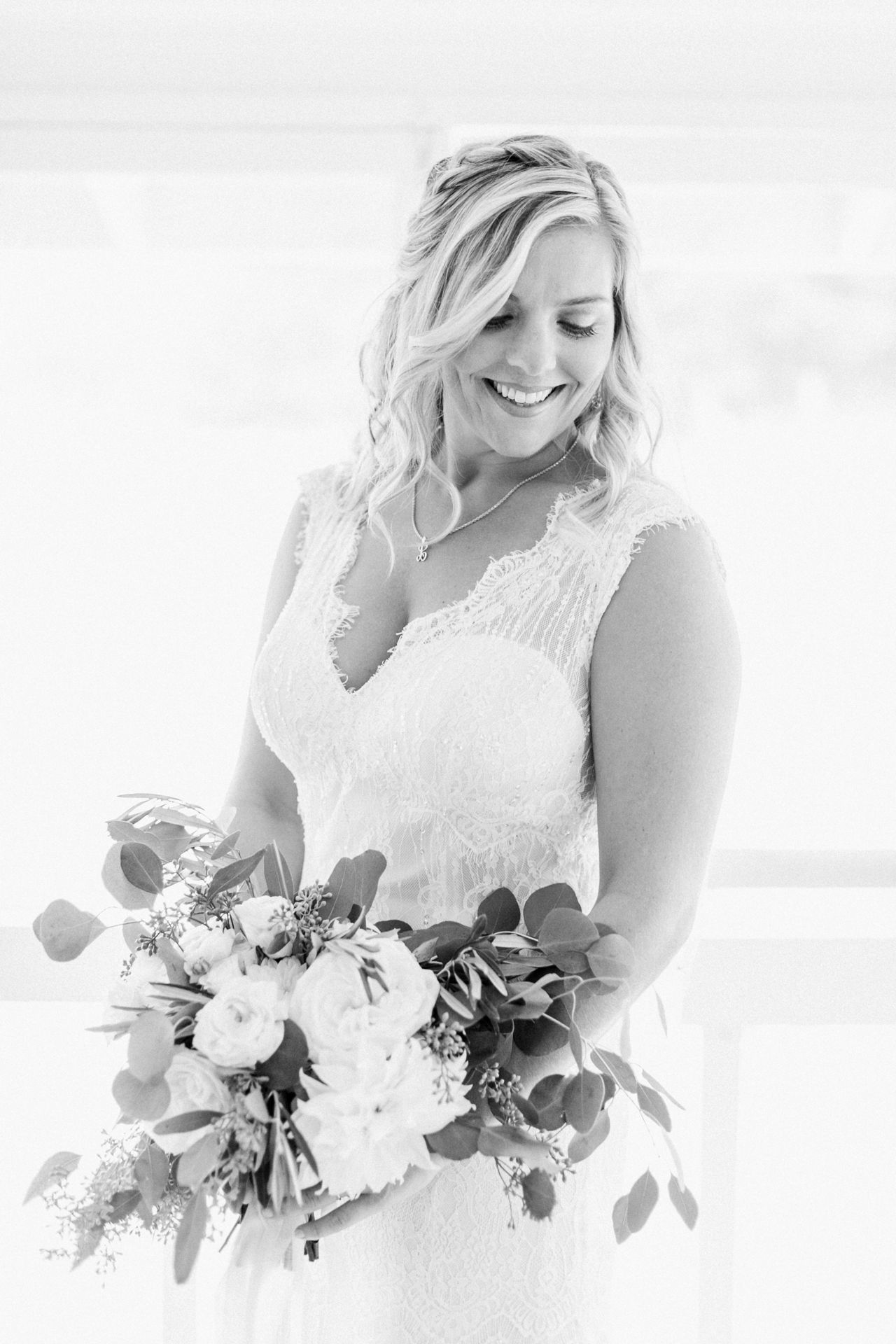 This is a portrait of a bride looking down her left shoulder while holding her bouquet in a cabin at Fountain Point Resort