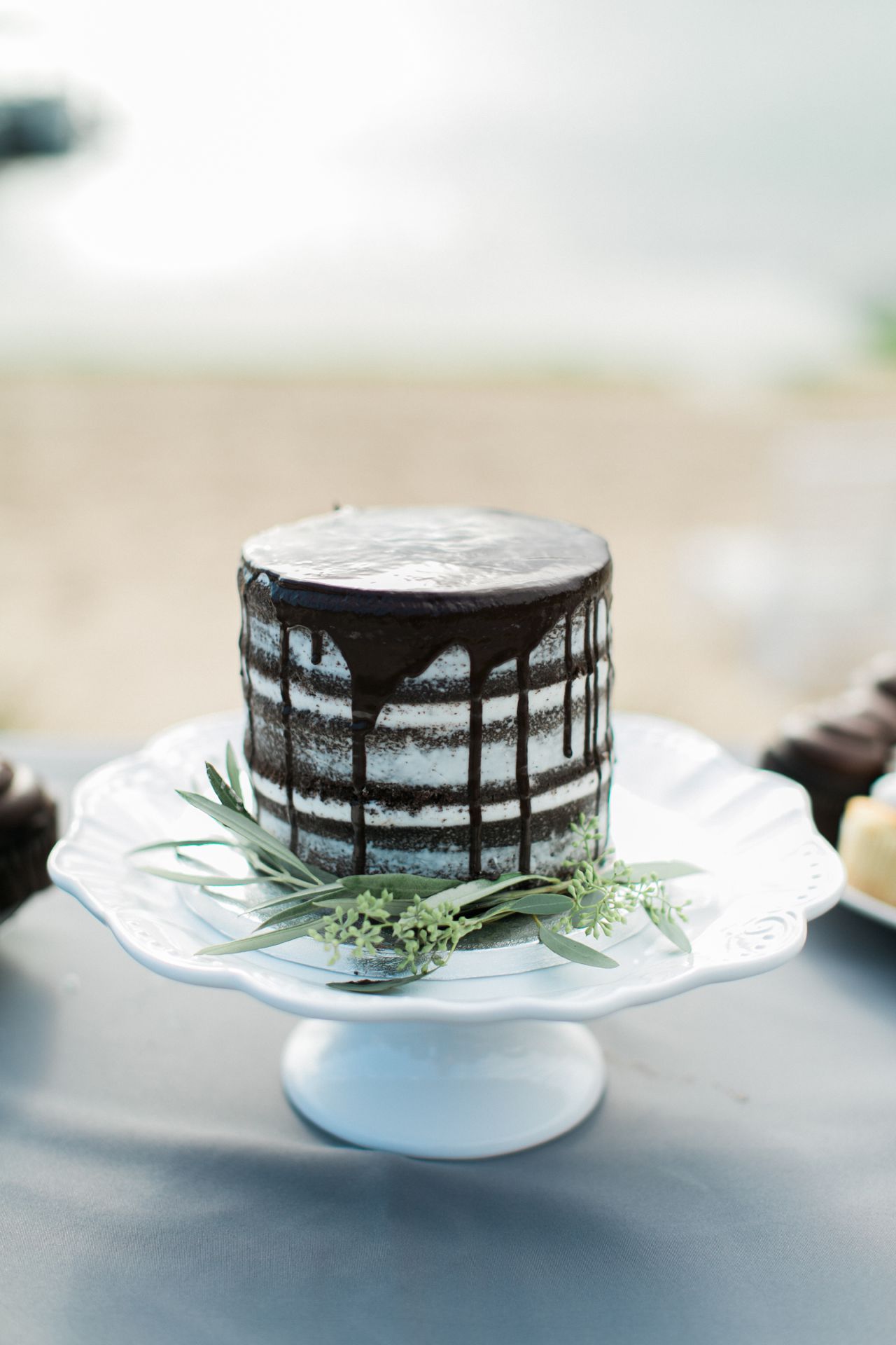 This is a photo of a chocolate wedding cake with Lake Leelanau in the background