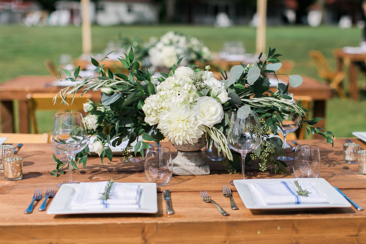 This is a wedding wedding reception centerpiece with white flowers and greenery at Fountain Point Resort