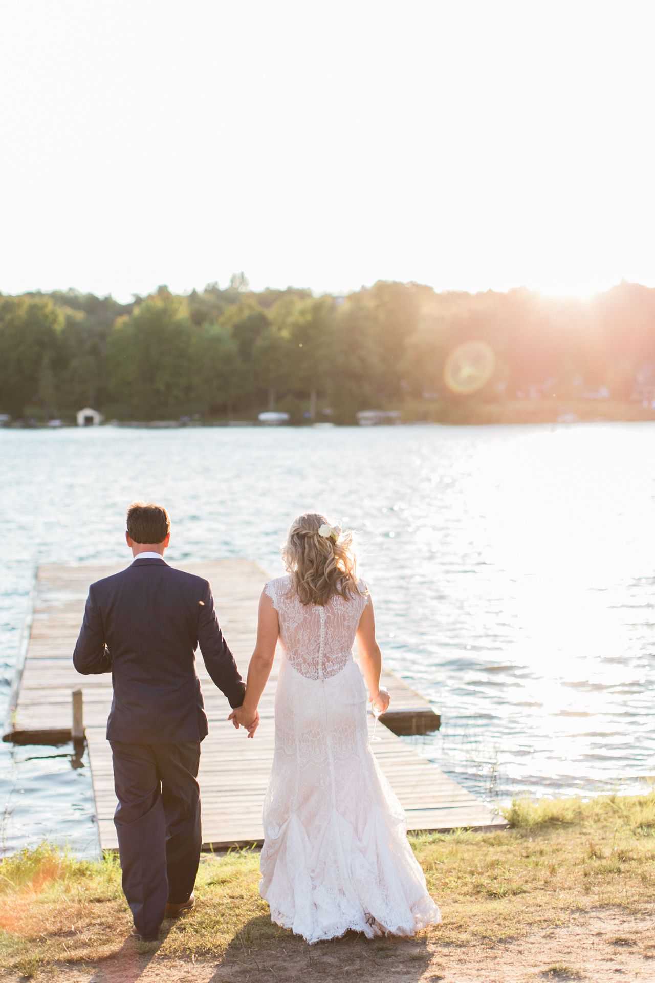 This is a photo of a bride and groom walking on a dock at Fountain Point Resort