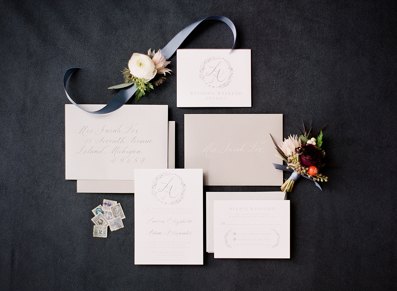 A wedding invitation suite on a black background