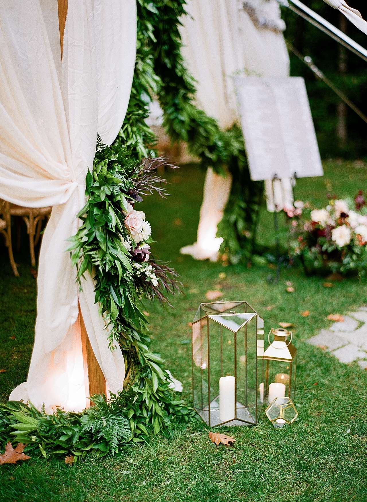 A reception tent entrance with candles and greenery at The Leelanau School