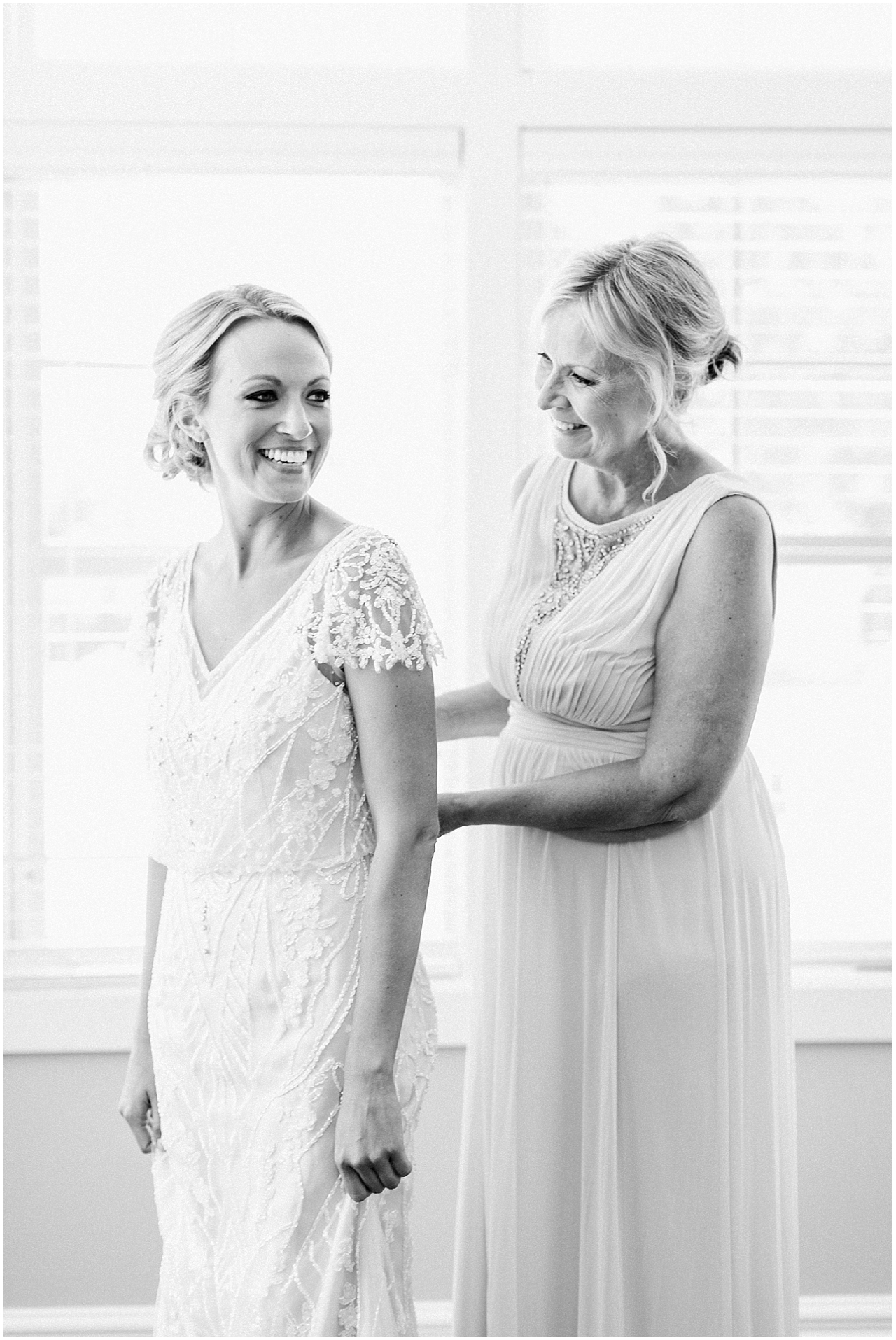 This is a bride getting her wedding dress on with the help of her mother in Bay Harbor, Michigan
