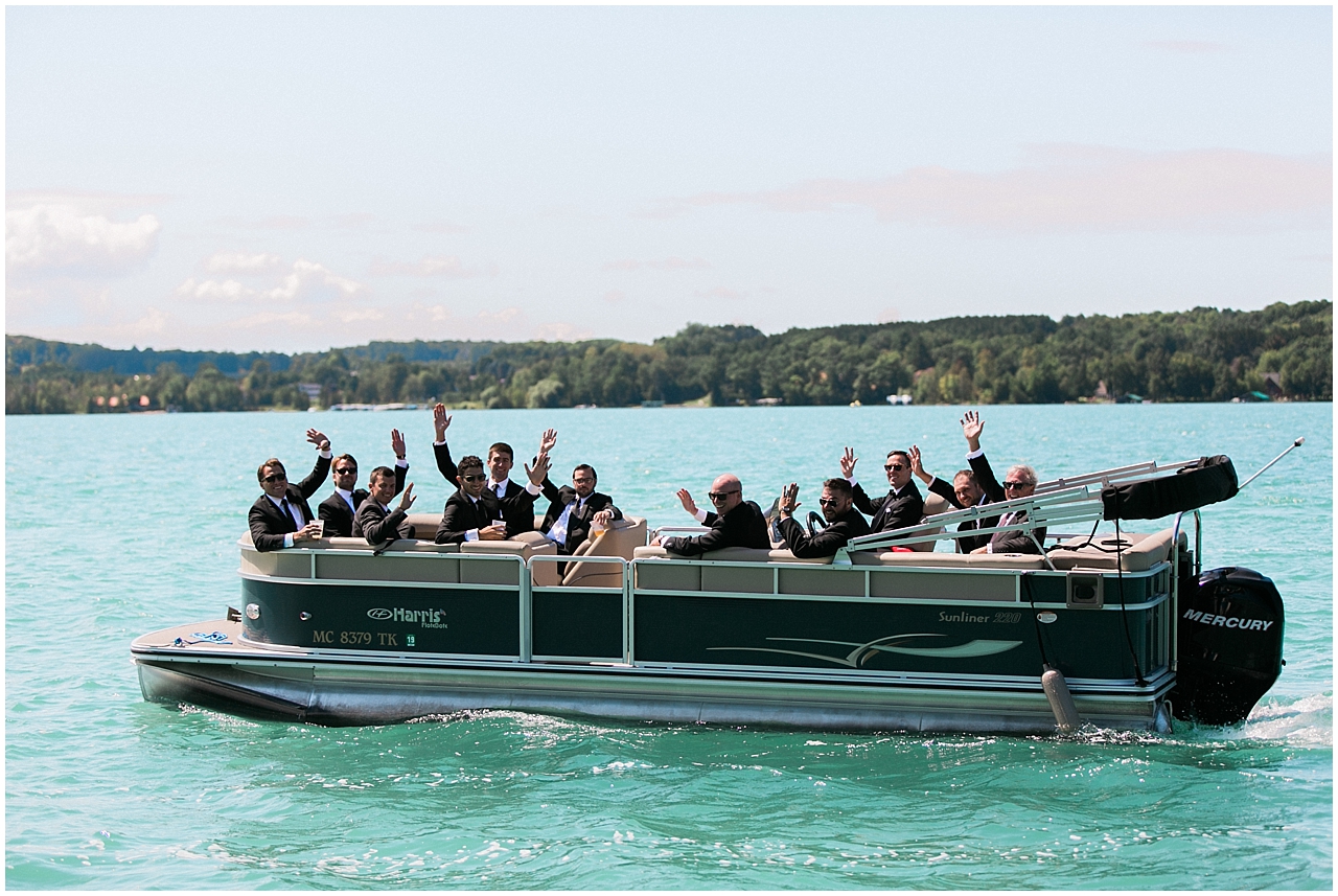 Groom and groomsmen taking a boat ride on a sunny day on Walloon Lake