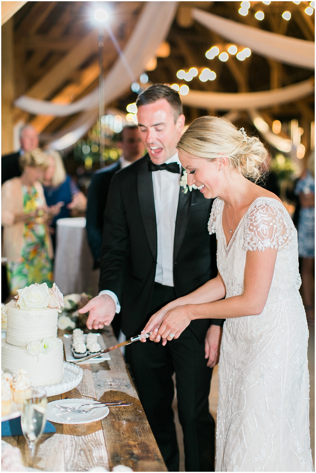 The bride and groom cutting their cake at Shanahan's barn in Charlevoix, Michigan