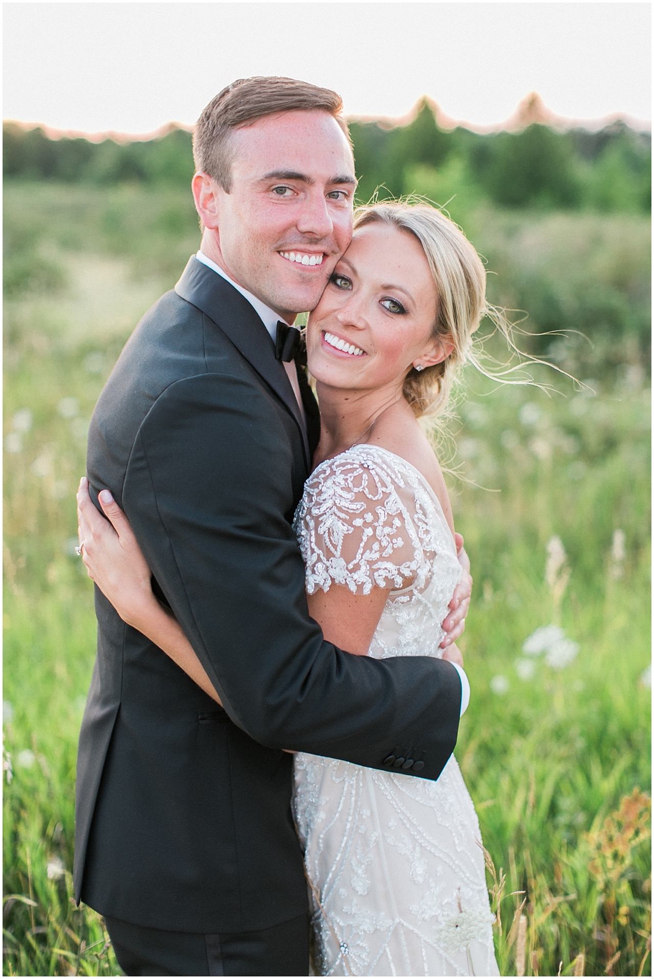 Bride and groom portraits during sunset in a field at Shanahan's barn in Charlevoix, Michigan