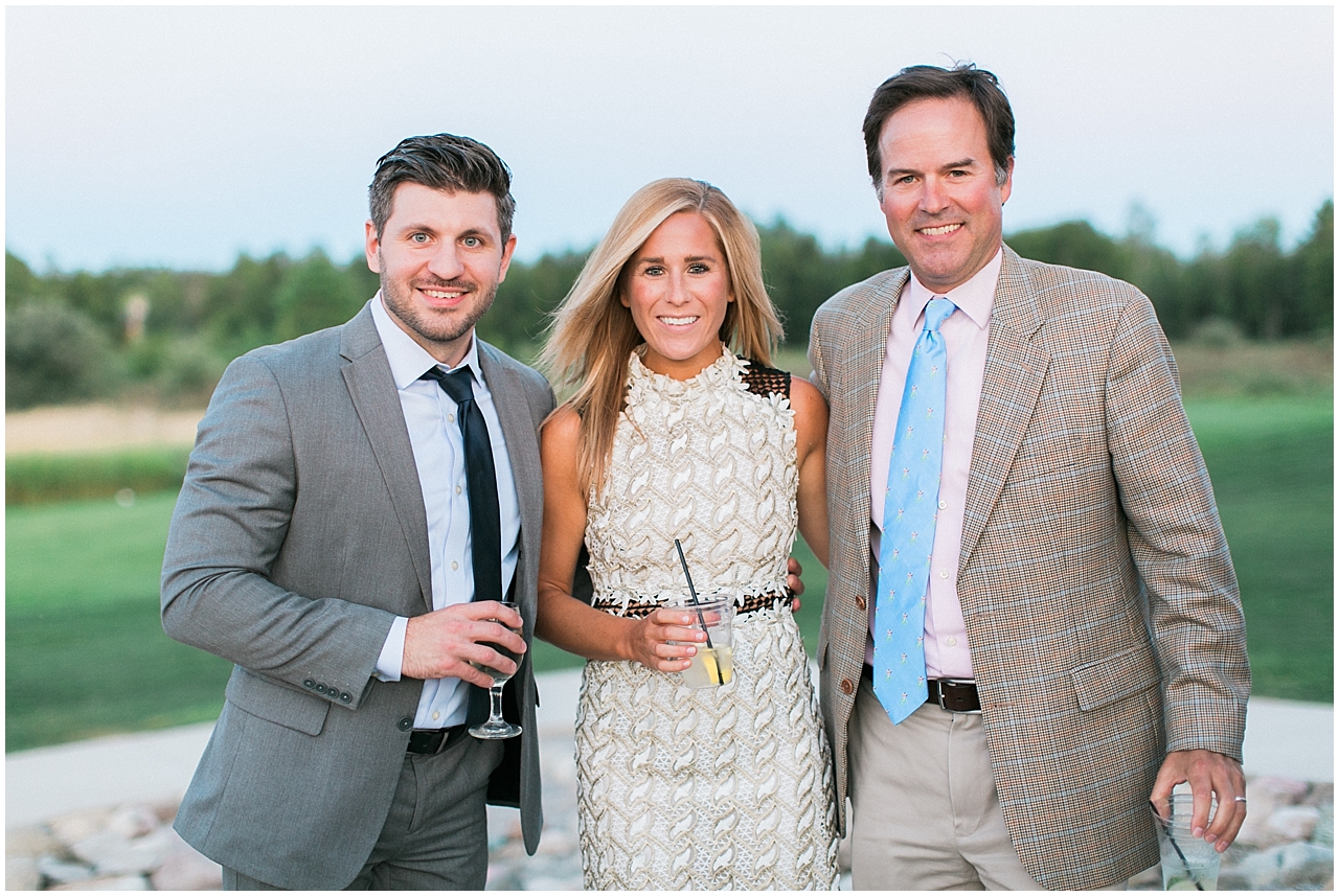 Wedding guests at the cocktail on the patio of a barn in Charlevoix, Michigan