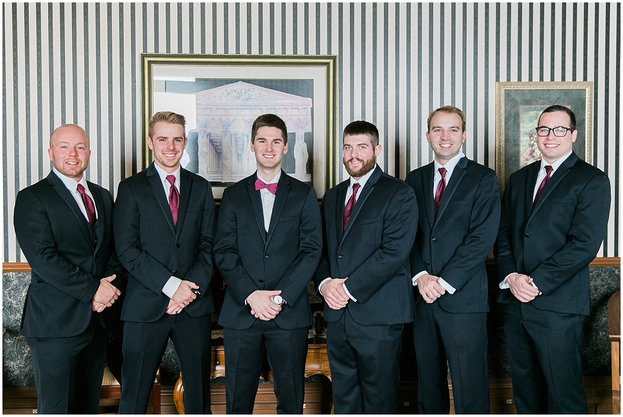 A groom and his groomsmen in the library at the Perry Hotel