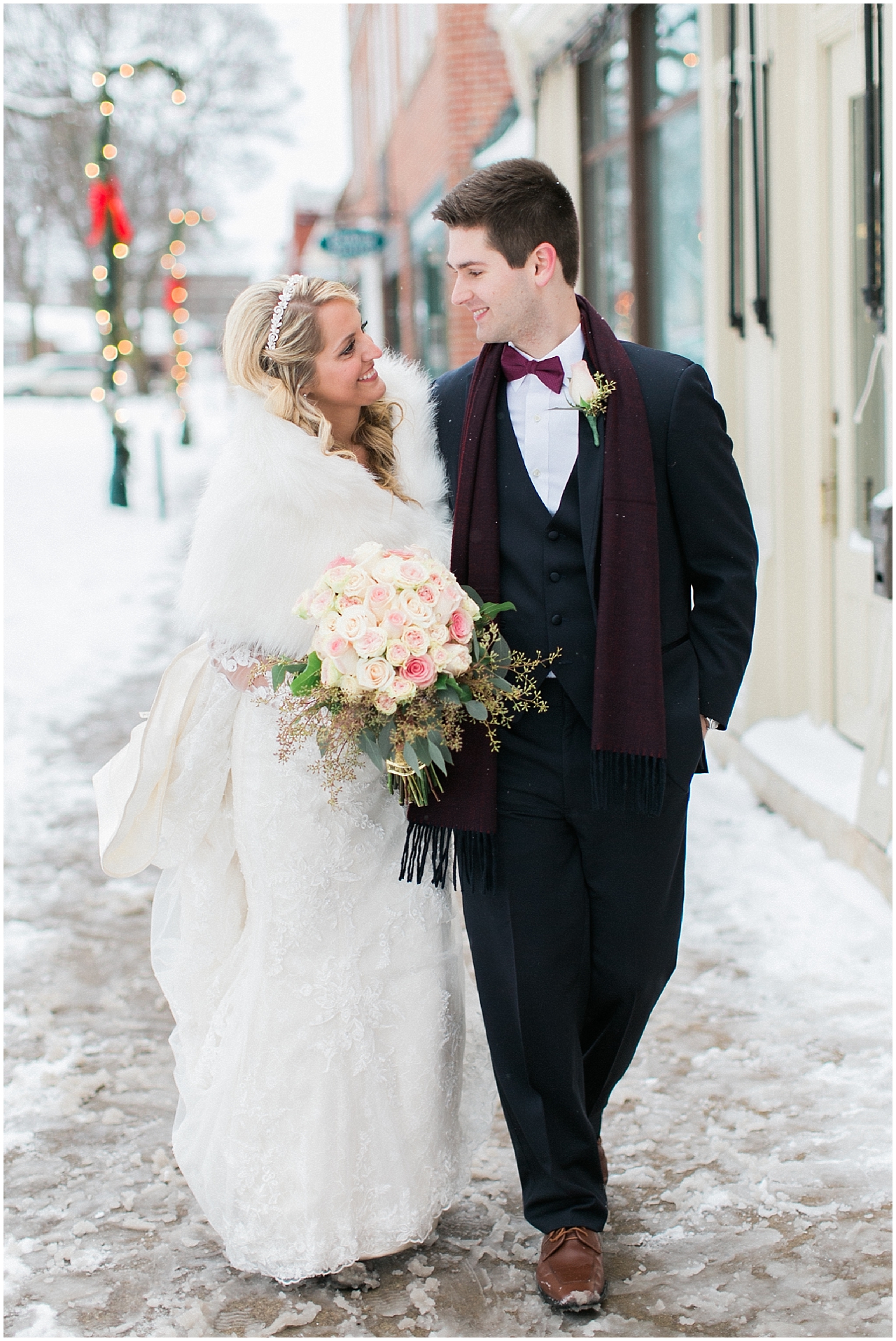 A bride and groom walking in Downtown Petoskey in the winter