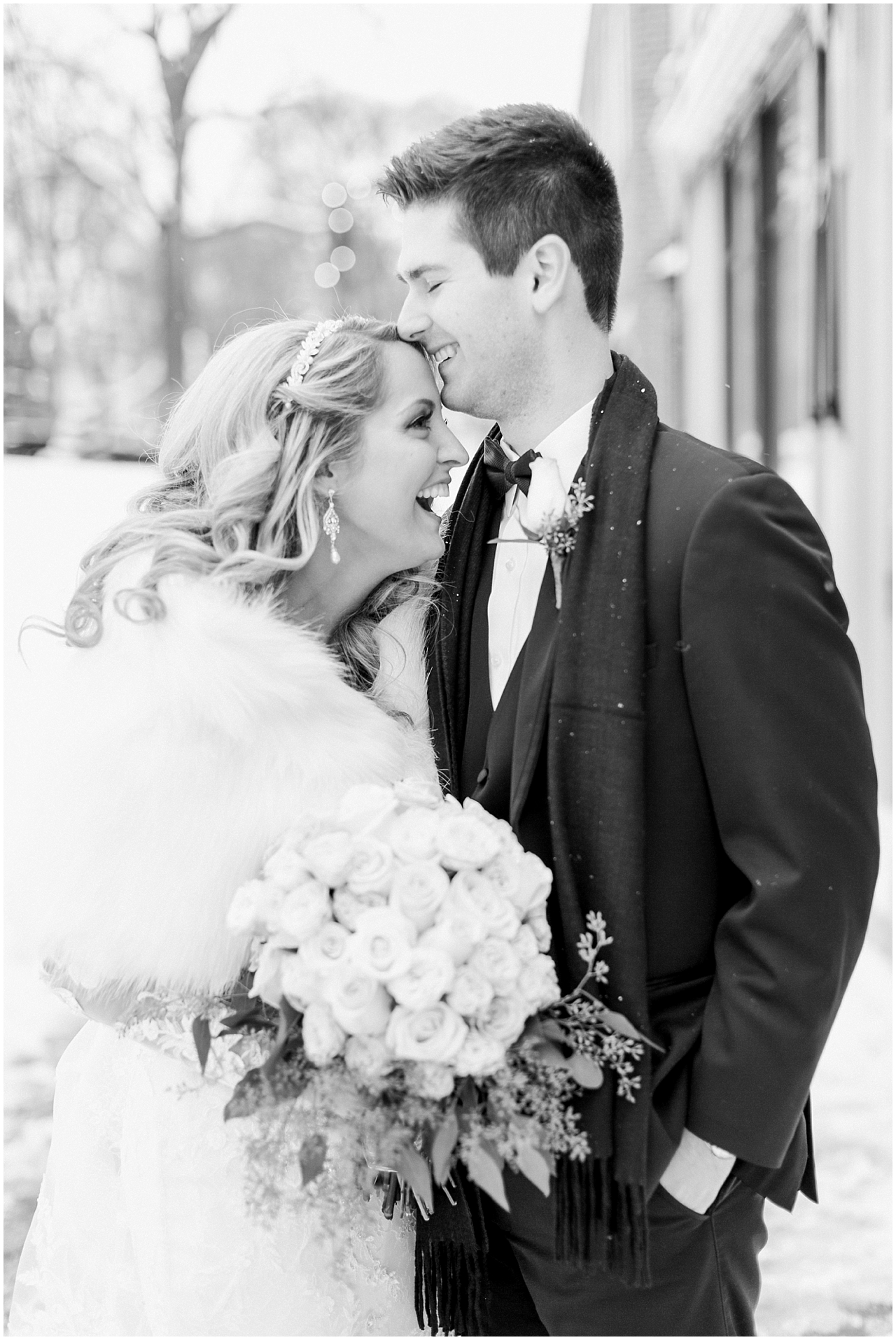 A bride and groom laughing at each other in Downtown Petoskey