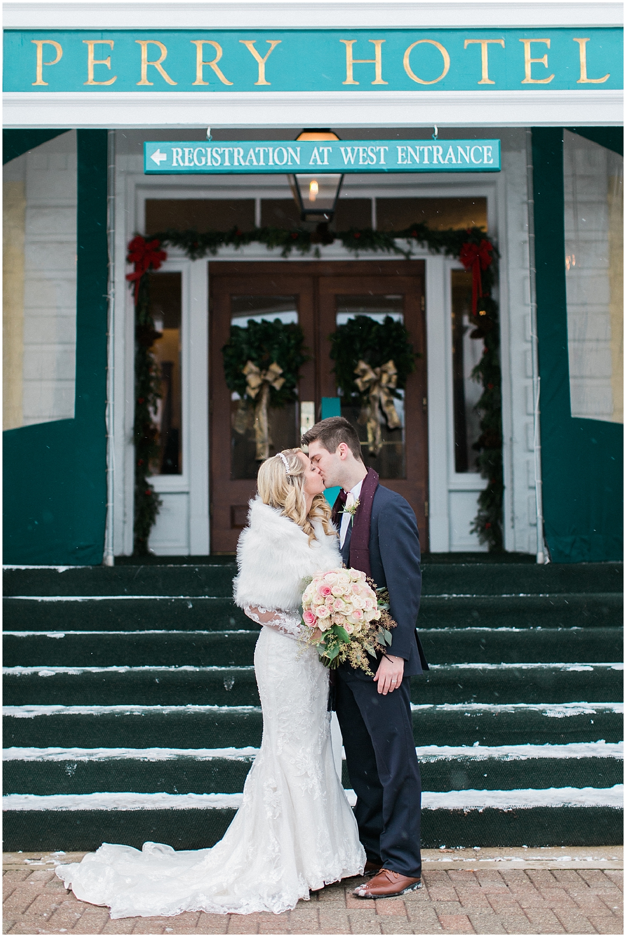 A bride and groom kissing in front of the Stafford's Perry Hotel in the winter