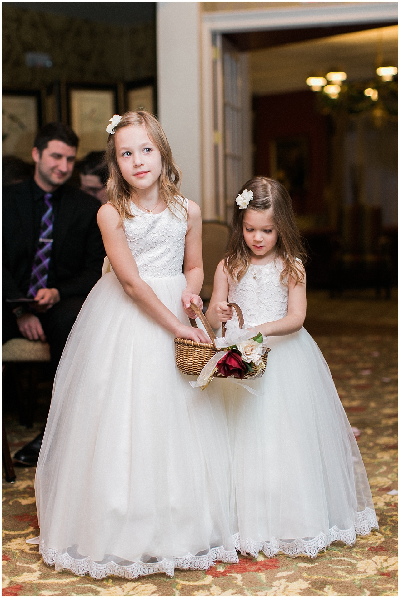 Flower girls walking down the aisle at the Stafford's Perry Hotel