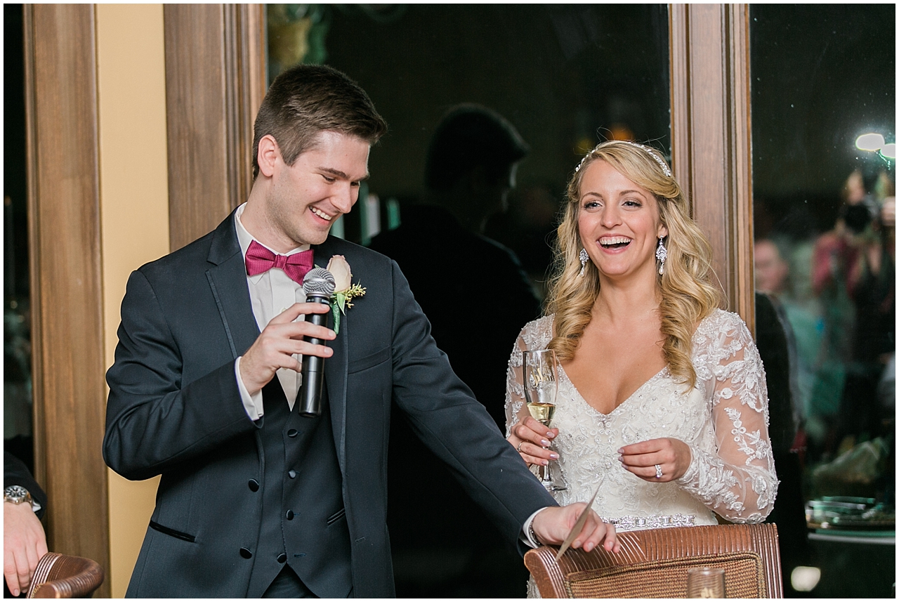 A bride and groom listening to toasts at their wedding reception at the Stafford's Perry Hotel
