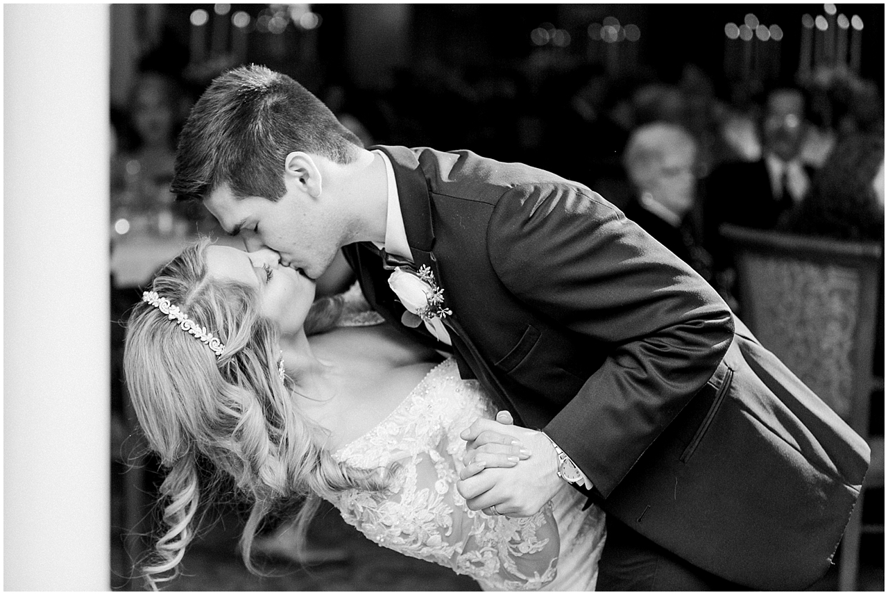 A bride and groom kissing during their first dance at the Stafford's Perry Hotel