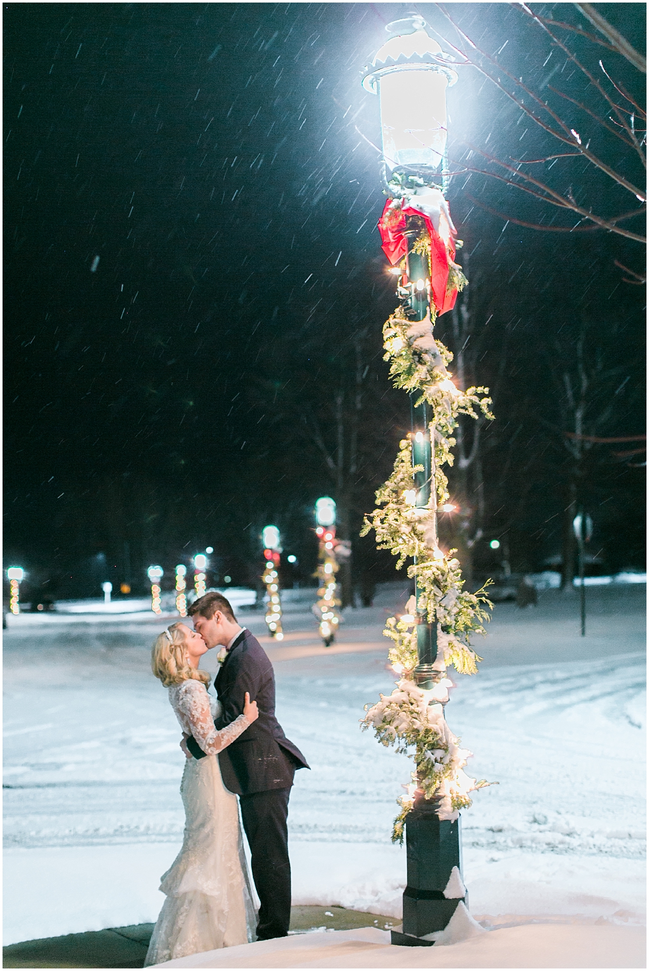 A bride and groom kissing outside the Stafford's Perry Hotel in the winter