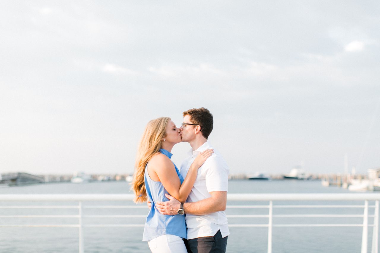 This is couple taking engagement photos at a marina in Traverse City, Michigan