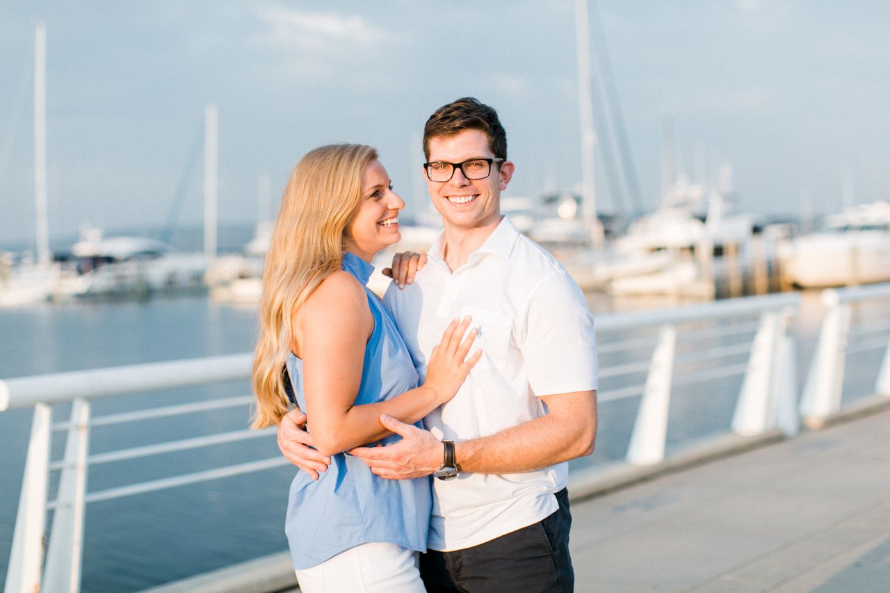 This is an engaged couple smiling outside in Michigan