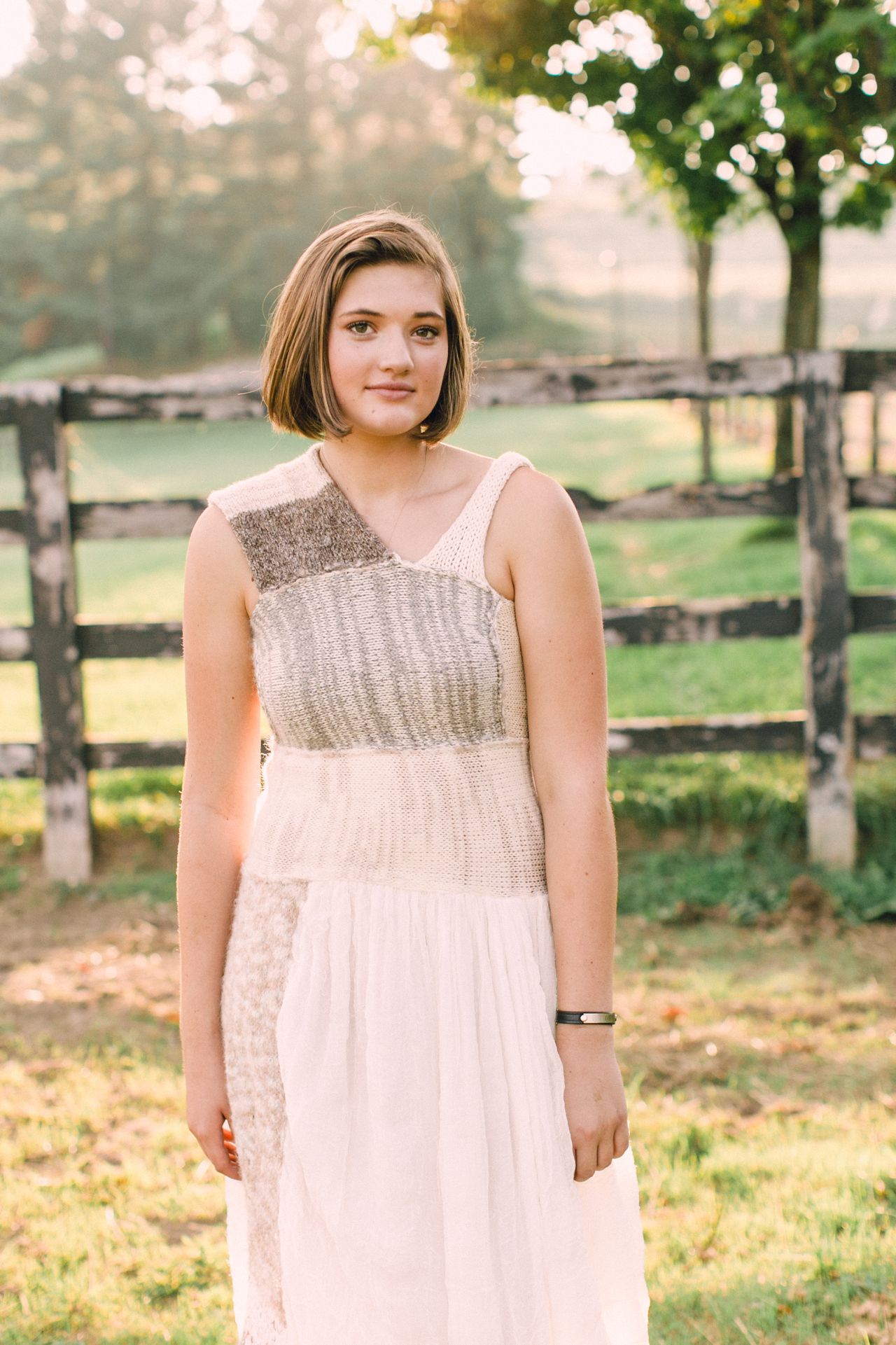 High school senior getting her senior portraits taken during sunset