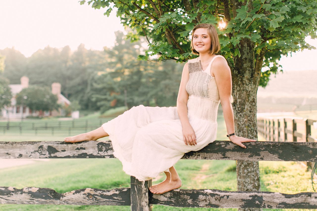 Girl sitting on a fence in Northern Michigan
