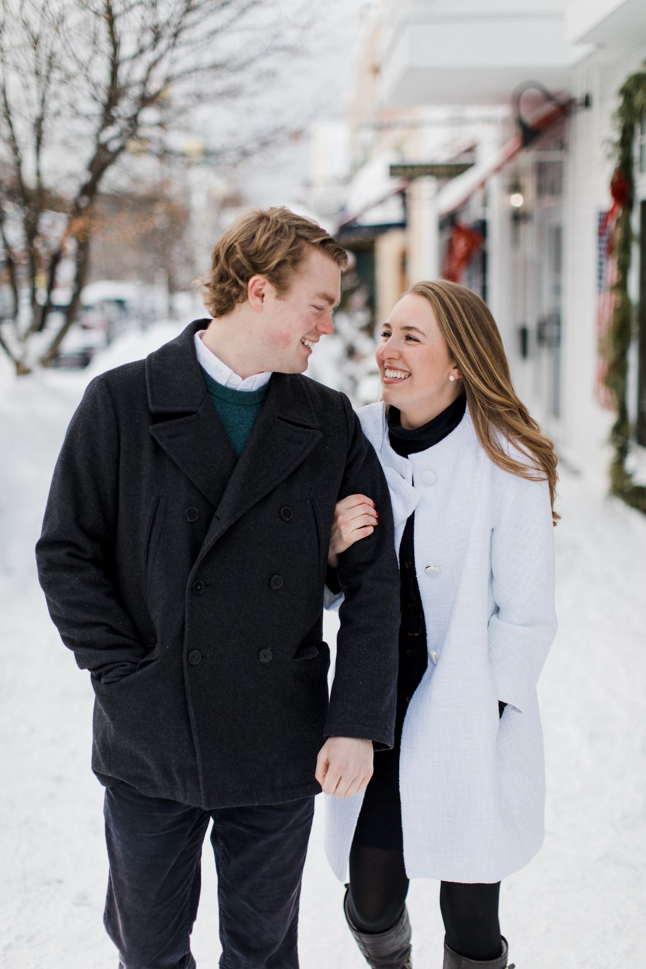 This is a couple walking in Downtown Harbor Springs after getting engaged