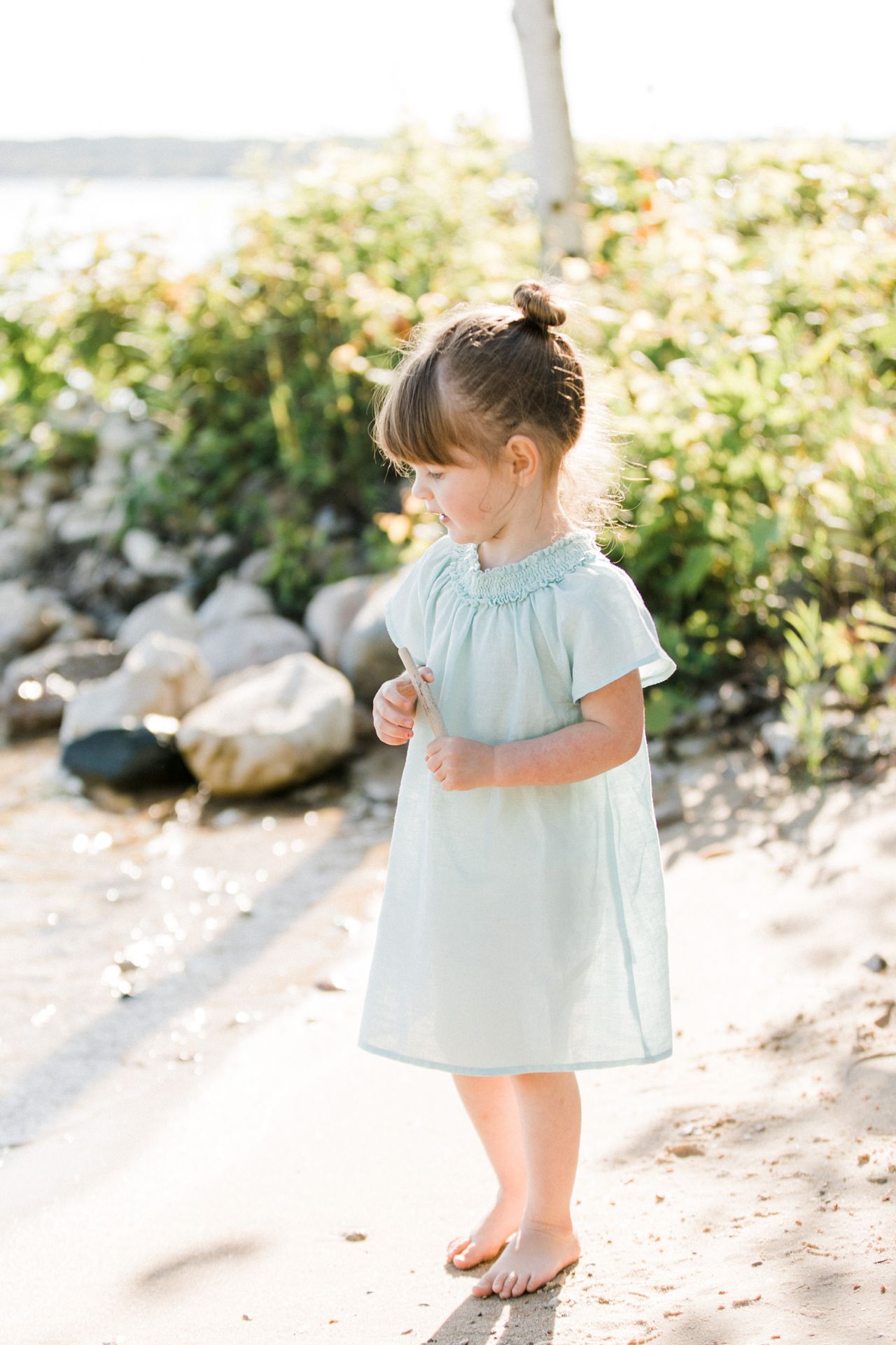A female toddler looking out at the water in Michigan