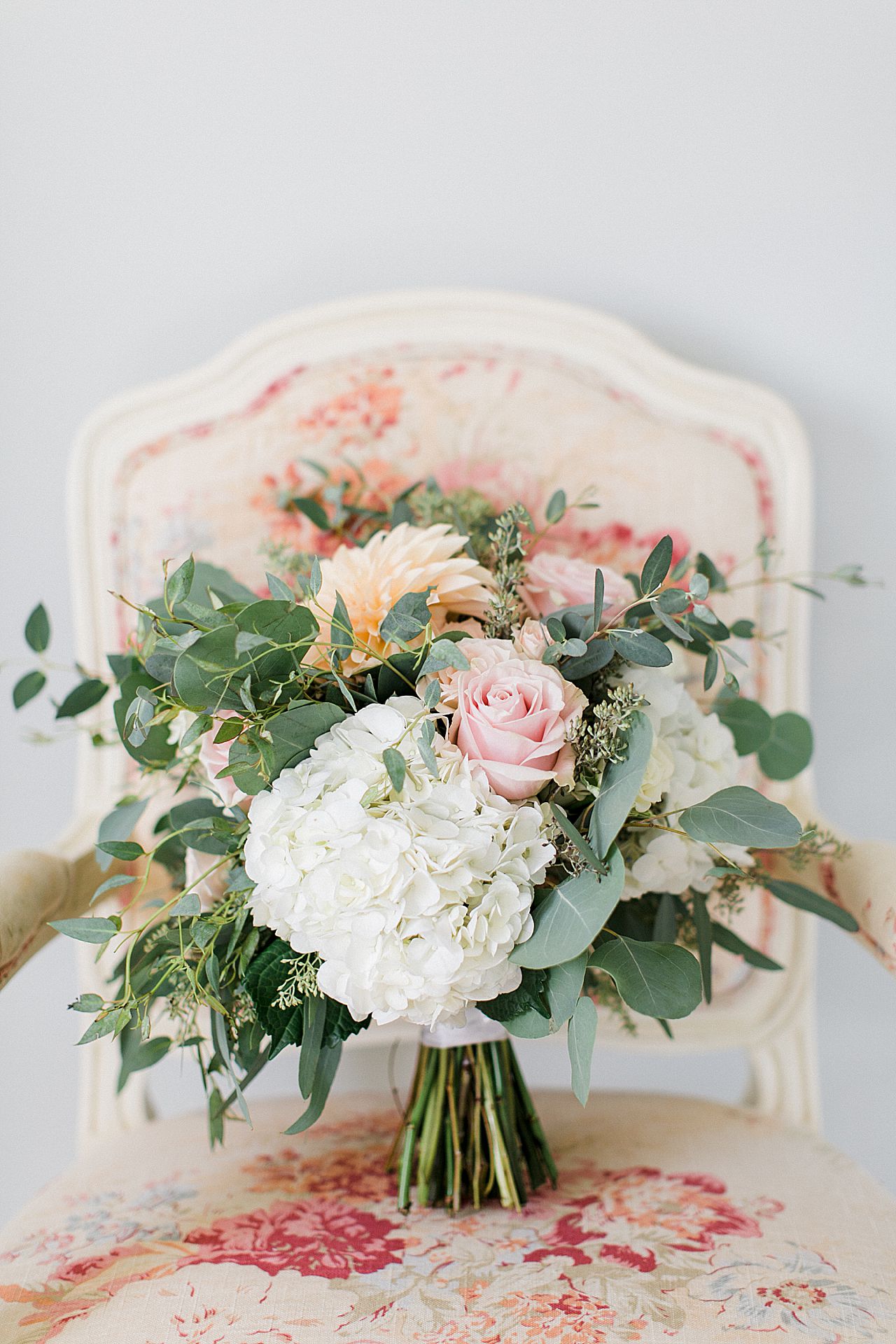 Bride's bouquet on a fancy chair in the bridal suite