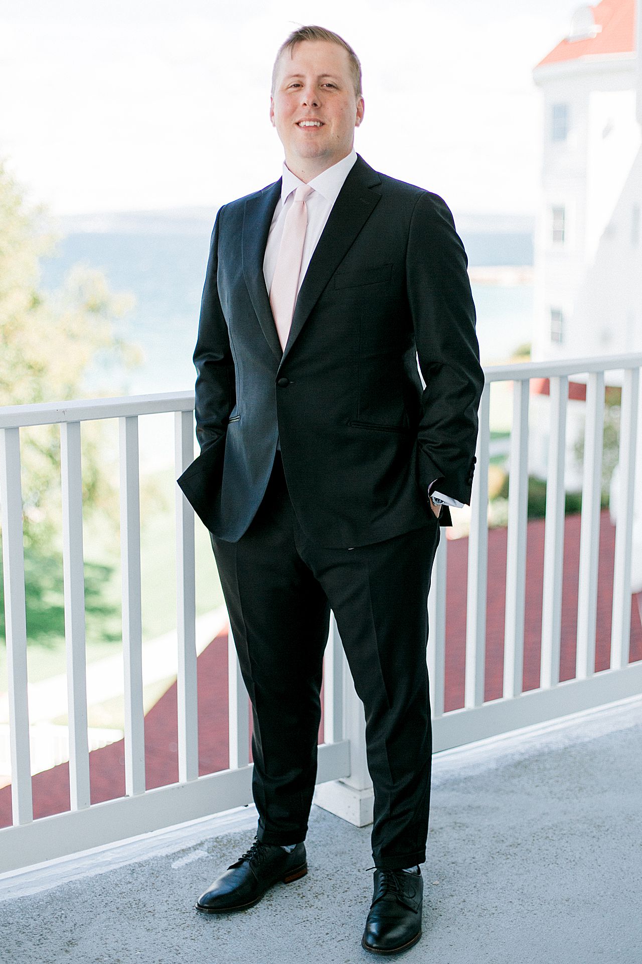 Groom portrait on the balcony of the Inn at Bay Harbor