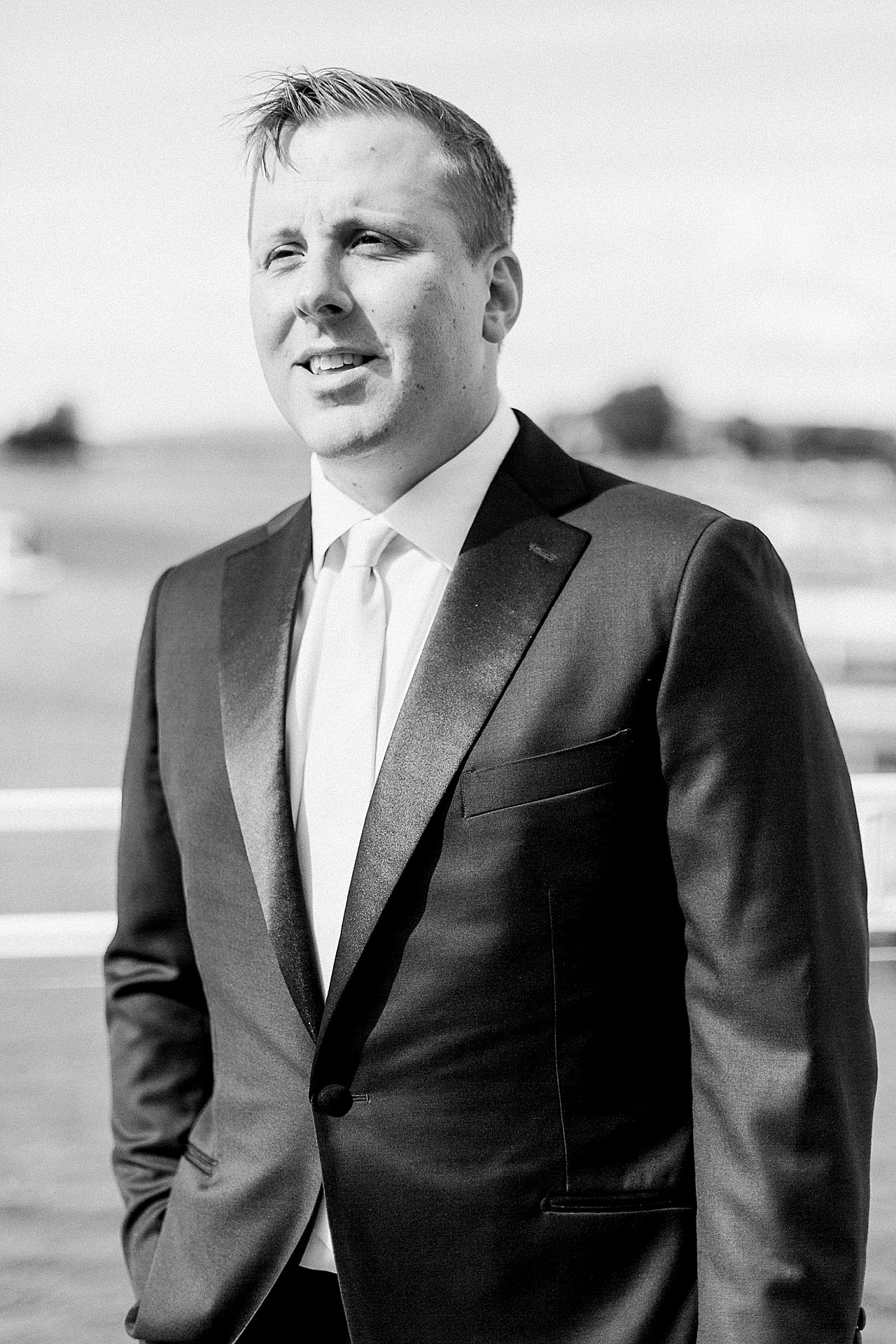 Black and white photo of a groom on his wedding day