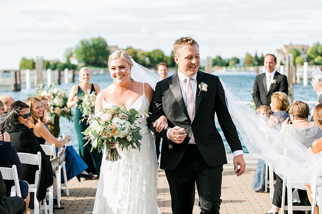 Newly married couple walking back down the aisle
