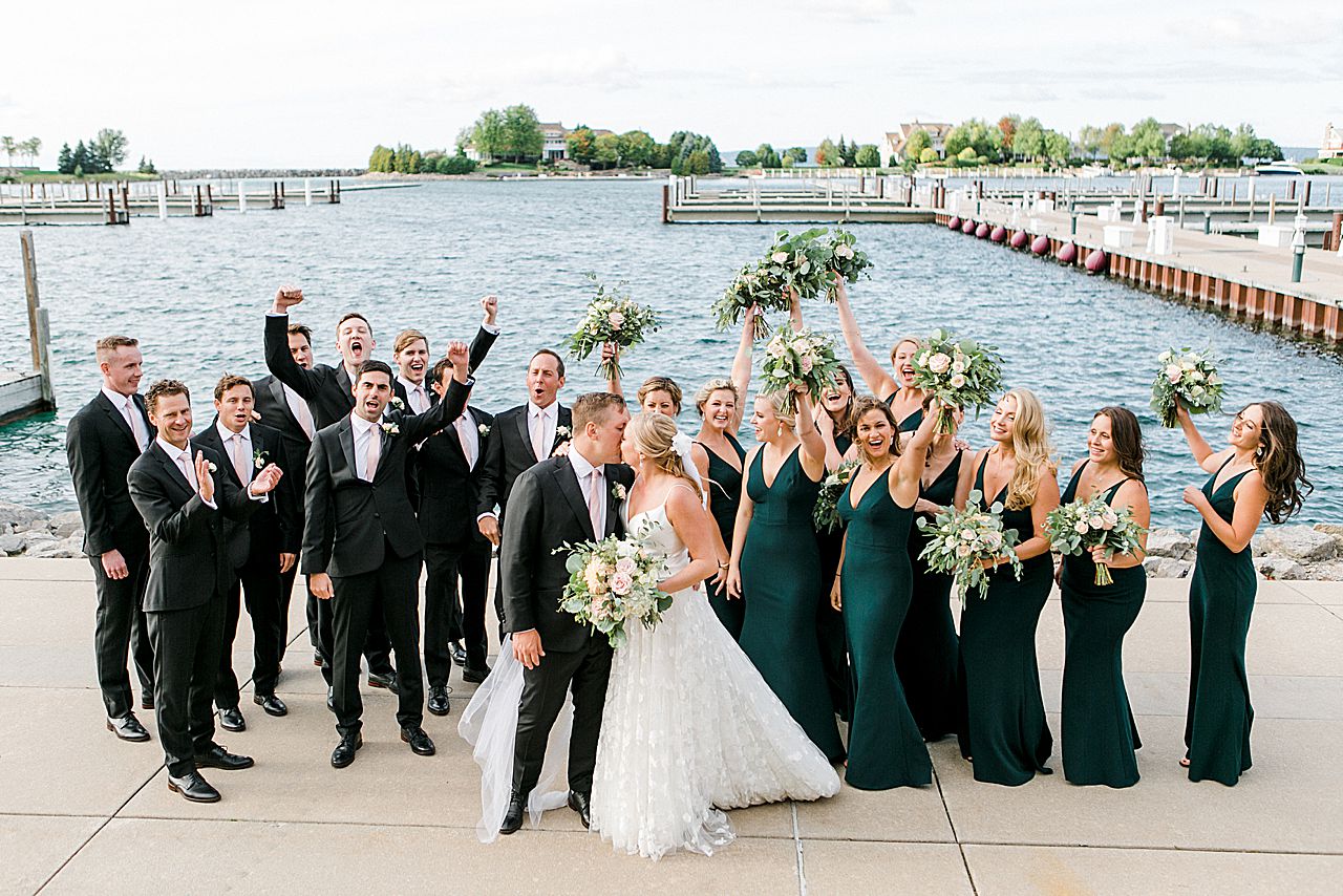 Wedding party cheering with the newly married couple