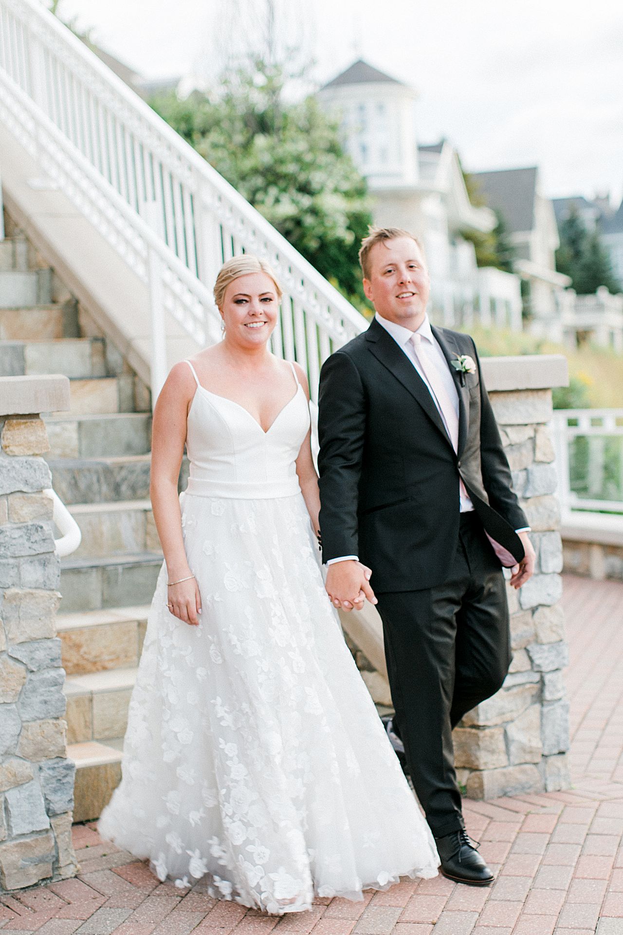Newly married couple walking around Bay Harbor, Michigan
