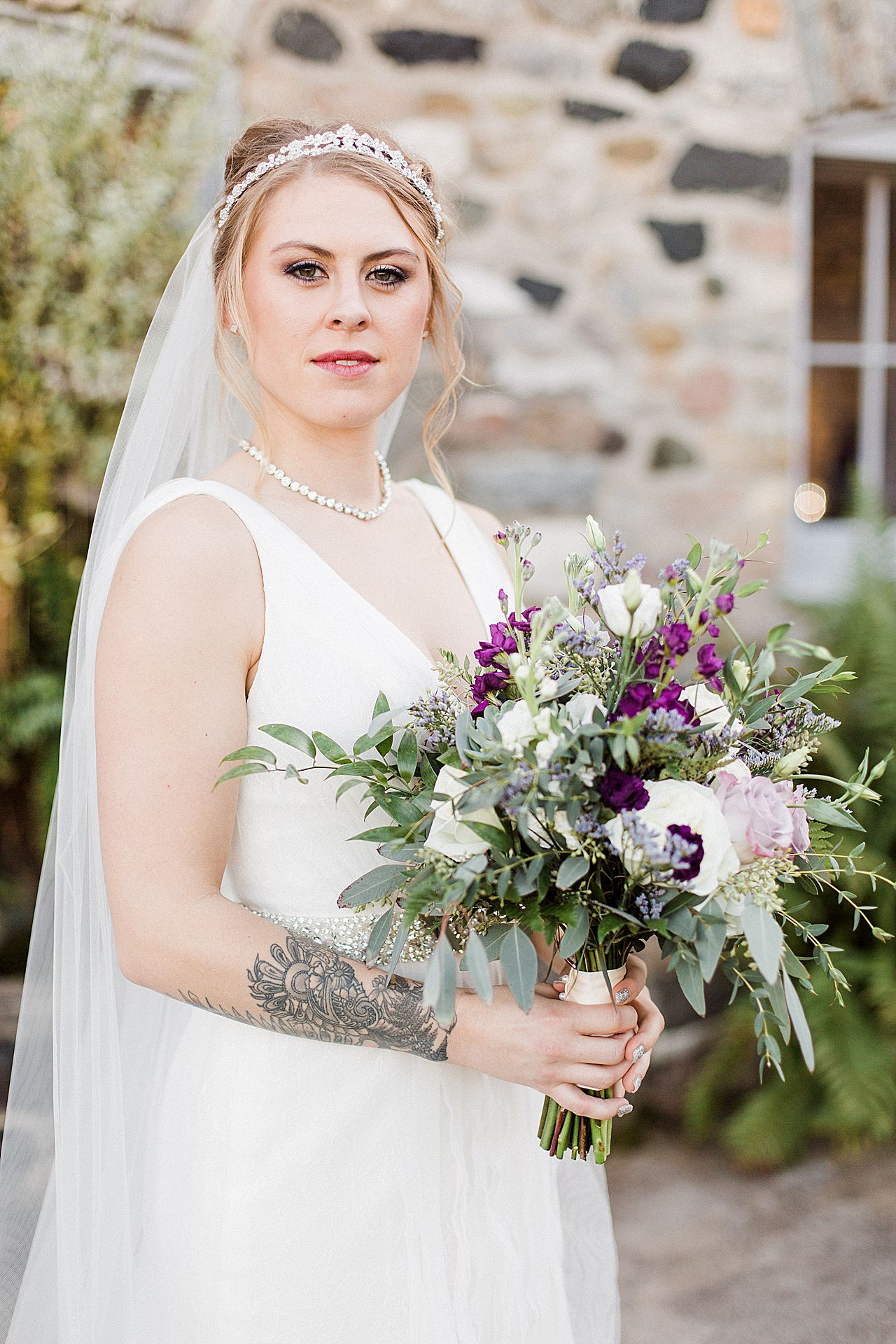 This is a photo of a bride holding a bouquet at Castle Farms