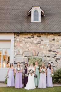 This is a photo of a bride smiling with her bridesmaids at Castle Farms