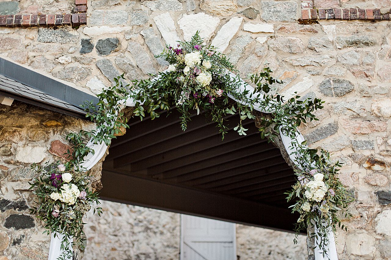 This is a photo of white flowers and greenery at a ceremony in the Knight's Courtyard in Charlevoix, Michigan