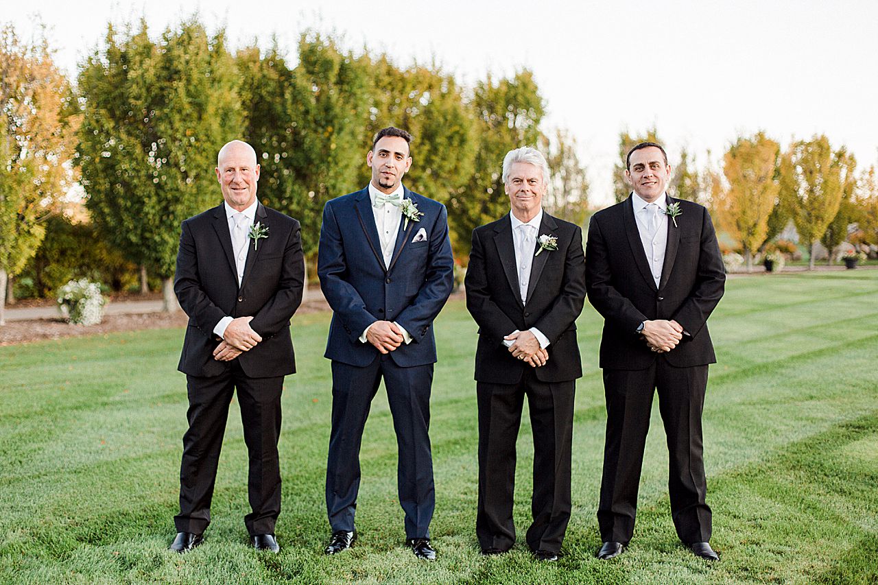 Groom and groomsmen portraits in the Kings Grand Courtyard in Charlevoix, Michigan