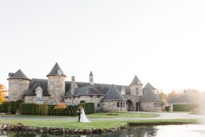 A bride and groom taking portraits by reflection pond at Castle Farms in Charlevoix, Michigan