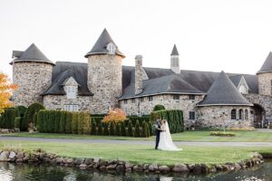 A bride and groom taking portraits by reflection pond at Castle Farms in Charlevoix, Michigan