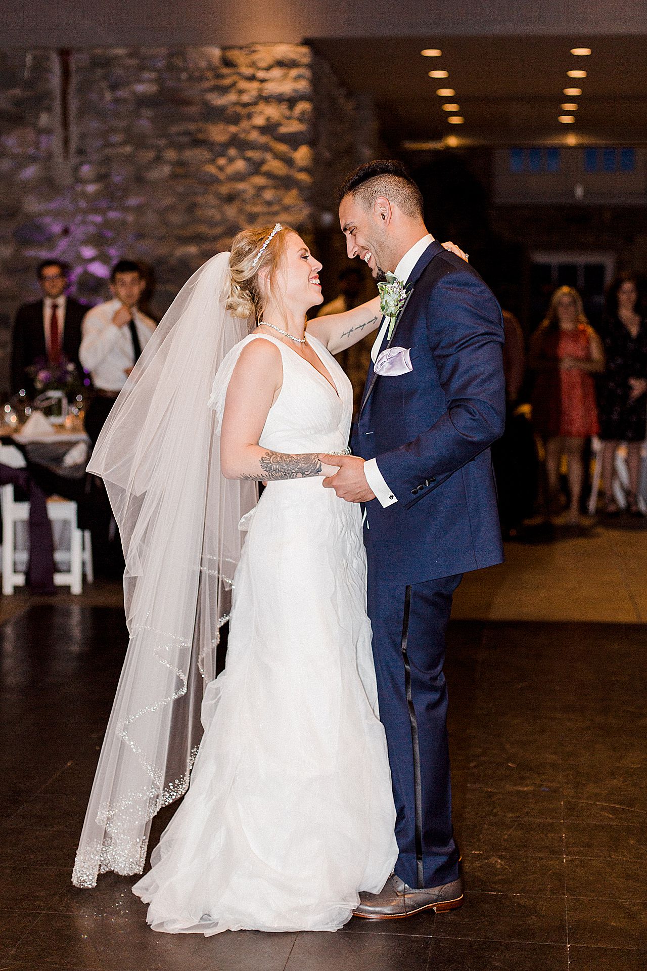 A bride and groom sharing their first dance during their reception in the Knight's Castle at Castle Farms in Charlevoix, Michigan