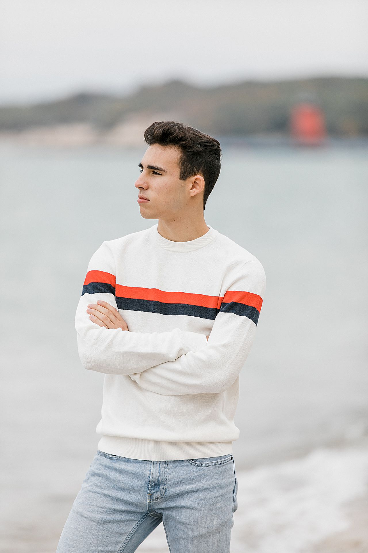 Senior looking off at the lake in Charlevoix, Michigan