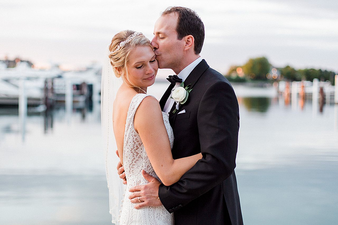 A newlywed couple by the lake at sunset